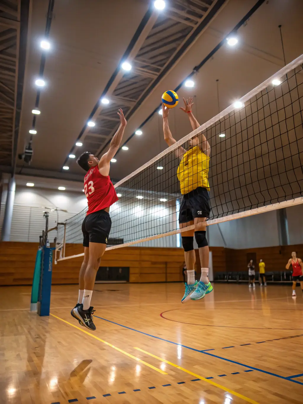 Students playing a game of volleyball in the school gymnasium, demonstrating teamwork and coordination.