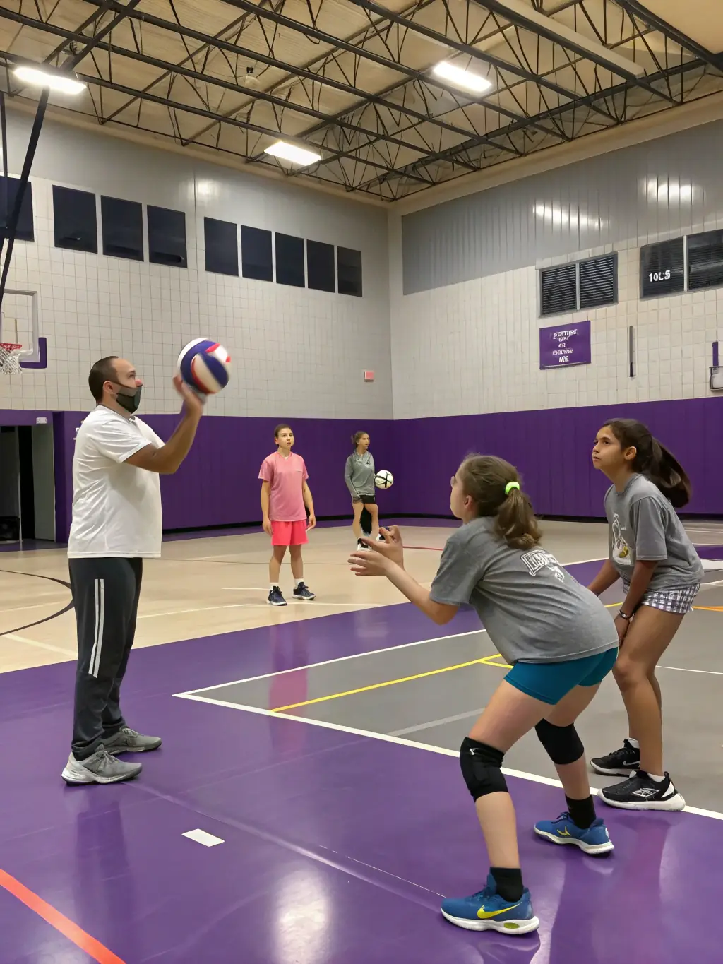 Students practicing their volleyball skills during a training session, emphasizing agility and precision.