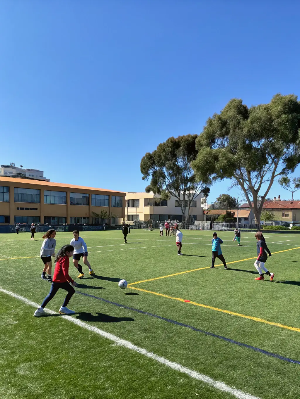 Students participating in a soccer match, demonstrating sportsmanship and teamwork, with the focus on fair play and collaboration.